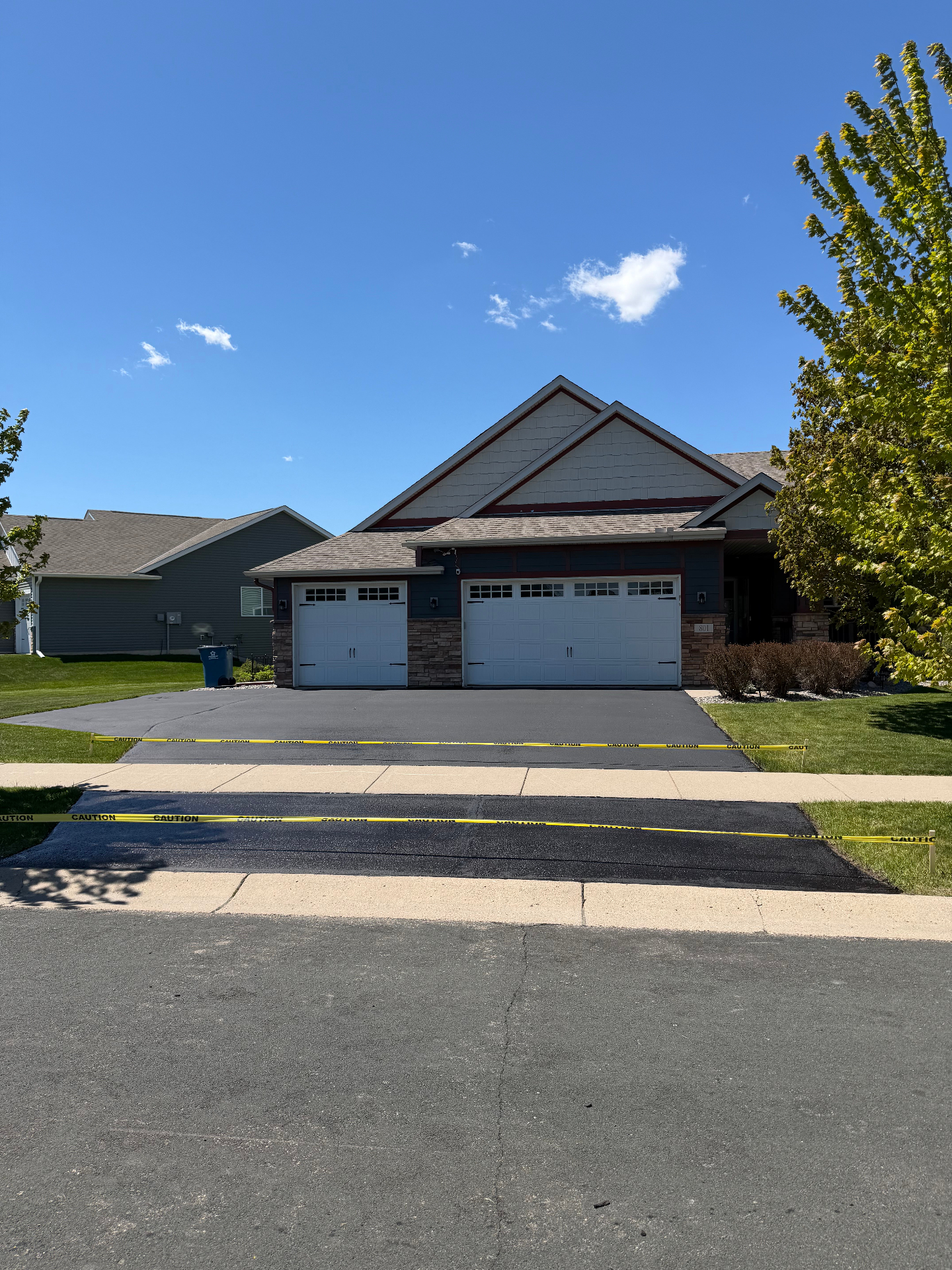 Asphalt driveway after crack filling and seal coating in Minnesota